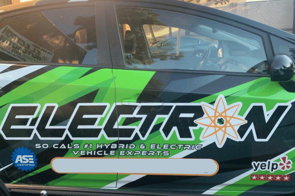 Electron Automotive technician using power tool on engine components