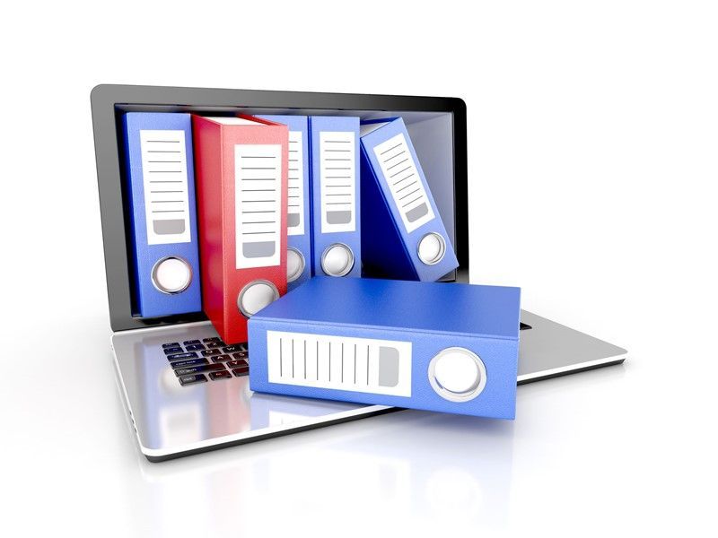 Laptop displaying colorful binders, symbolizing digital file management.