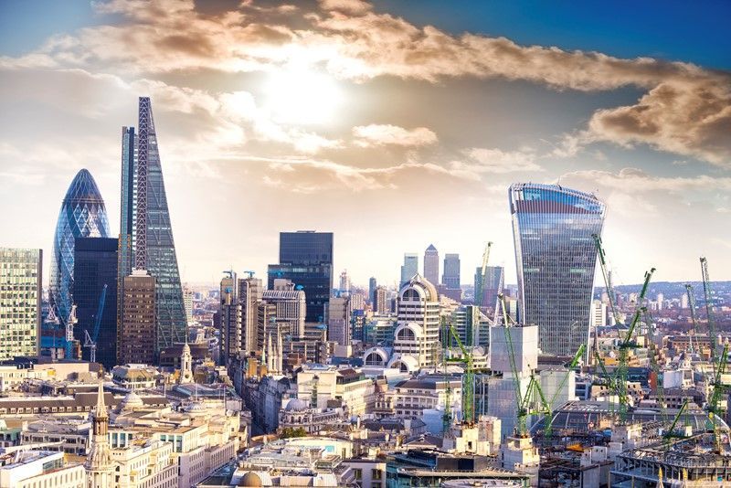 City of London skyline with modern skyscrapers under a sunny sky.