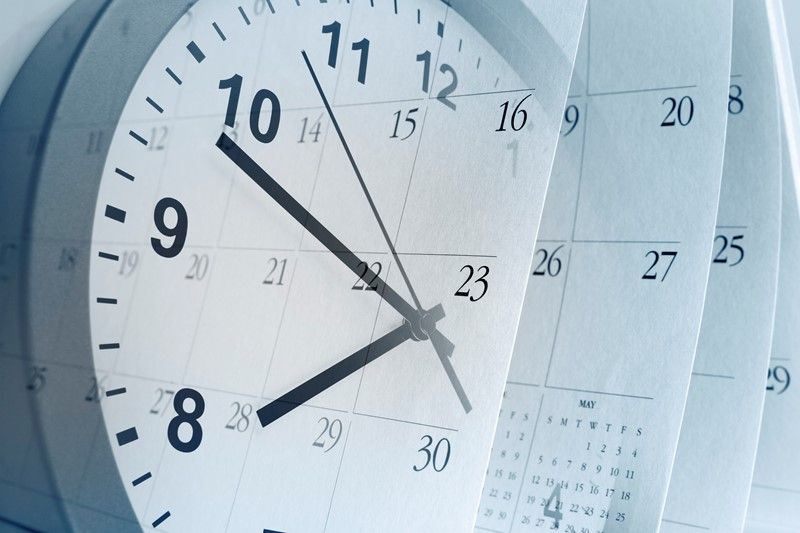 Clock face overlaid with calendar pages, suggesting time and scheduling.