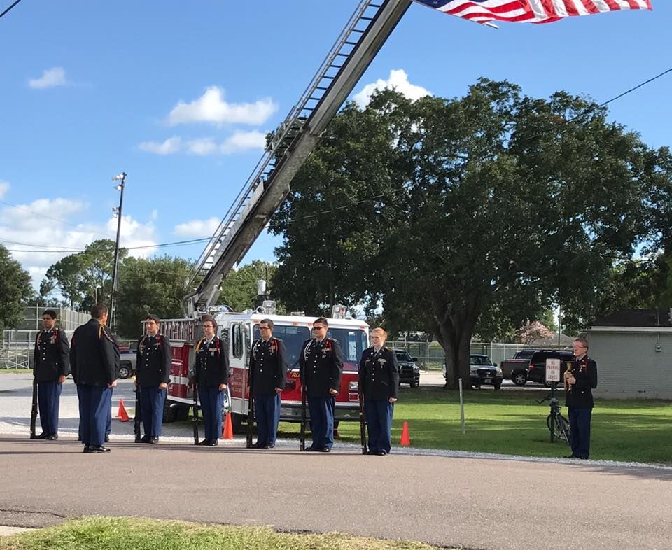 A group of men standing in front of a fire truck