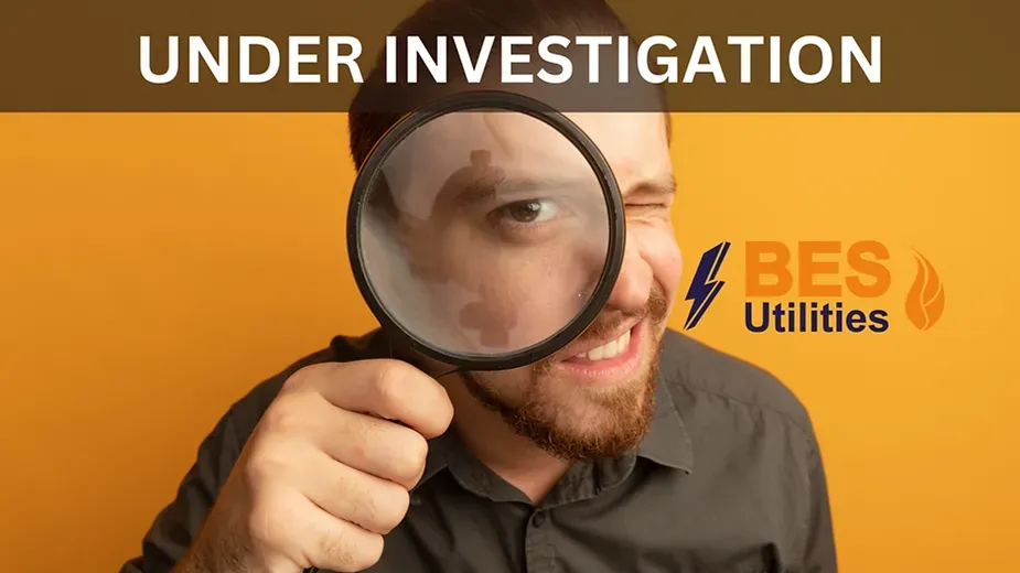 A man is looking through a magnifying glass at something.