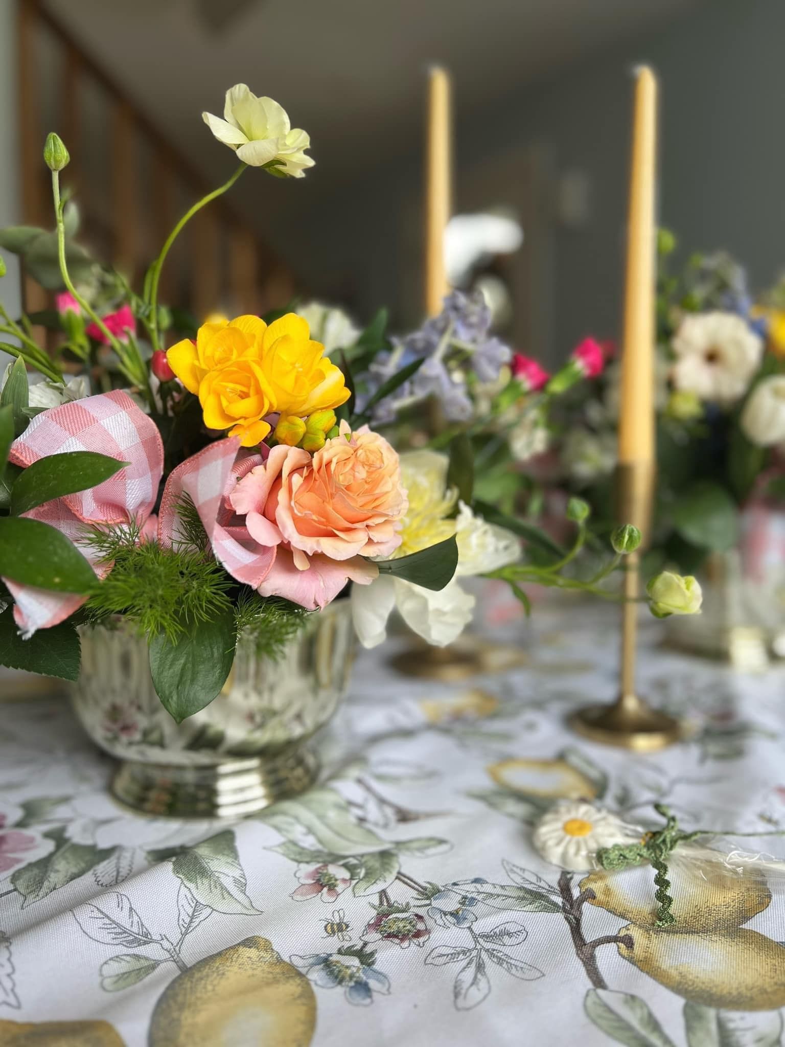 A wooden table with candles and flowers on it