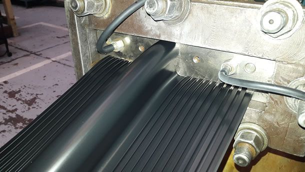 Un primer plano de una alfombra de goma negra en una máquina.