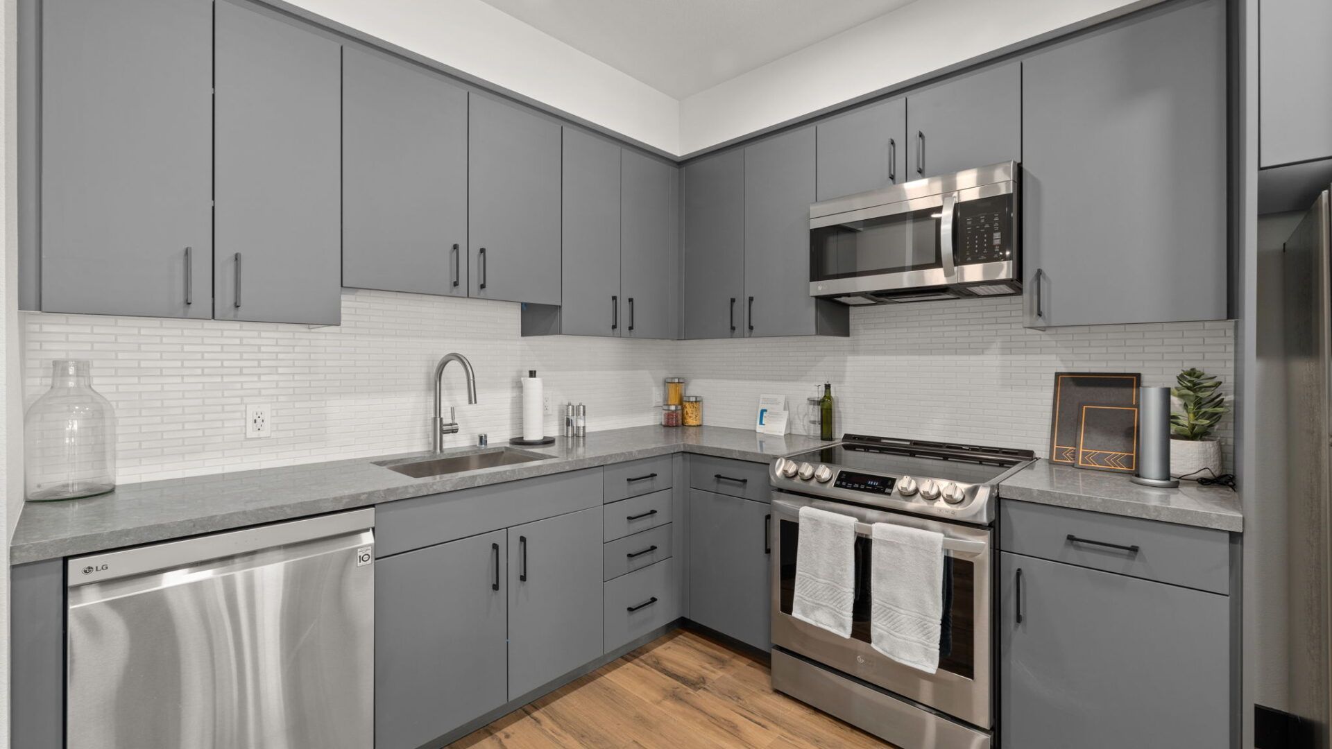 Gray kitchen with stainless steel appliances and gray cabinets at The Waymark in Walnut Creek, CA.