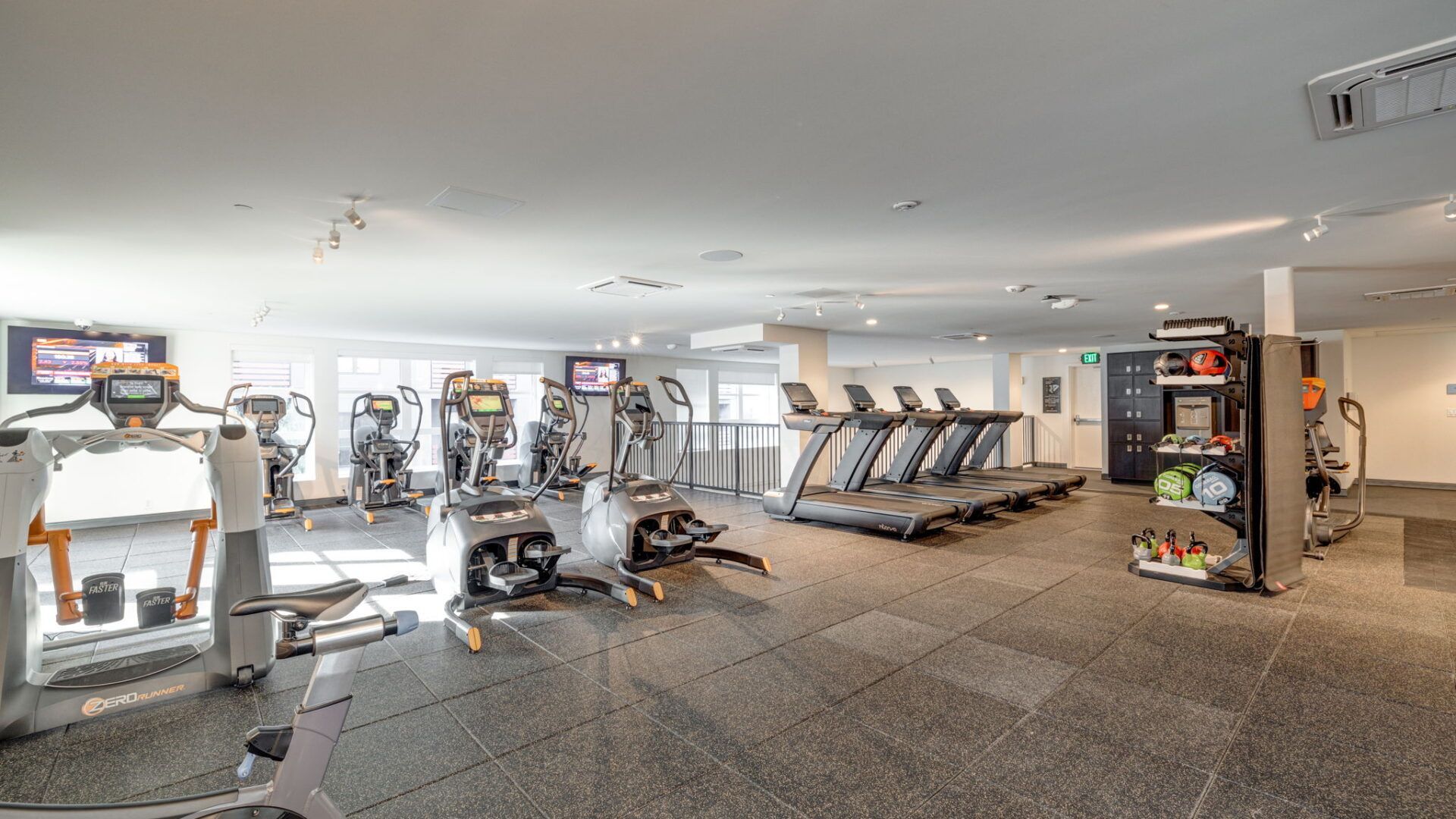 Gym interior with cardio machines, weight machines, and lockers at The Waymark in Walnut Creek, CA.