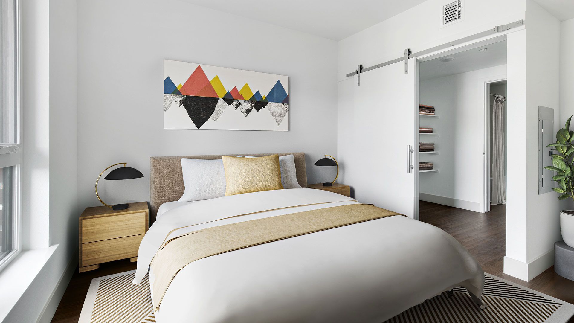 Bedroom with bed, art, nightstands, sliding door to hallway, and potted plant. White walls, neutral colors at The Waymark in Walnut Creek, CA.