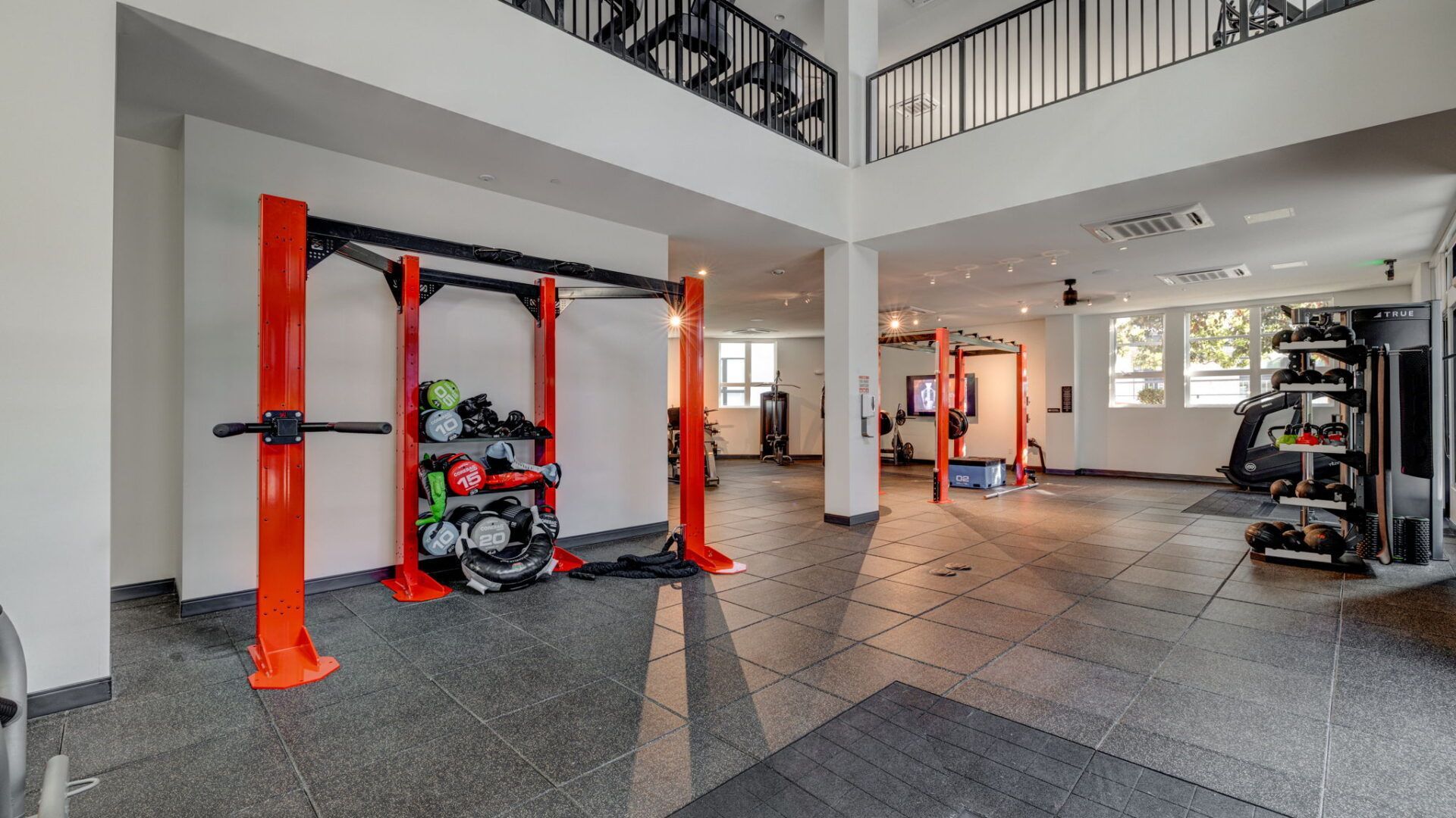 Gym interior with weight rack, equipment, and a mezzanine level at The Waymark in Walnut Creek, CA.