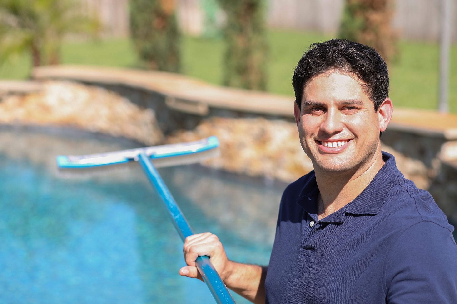 A person holding a pool cleaner for a Swimming Pool Repair