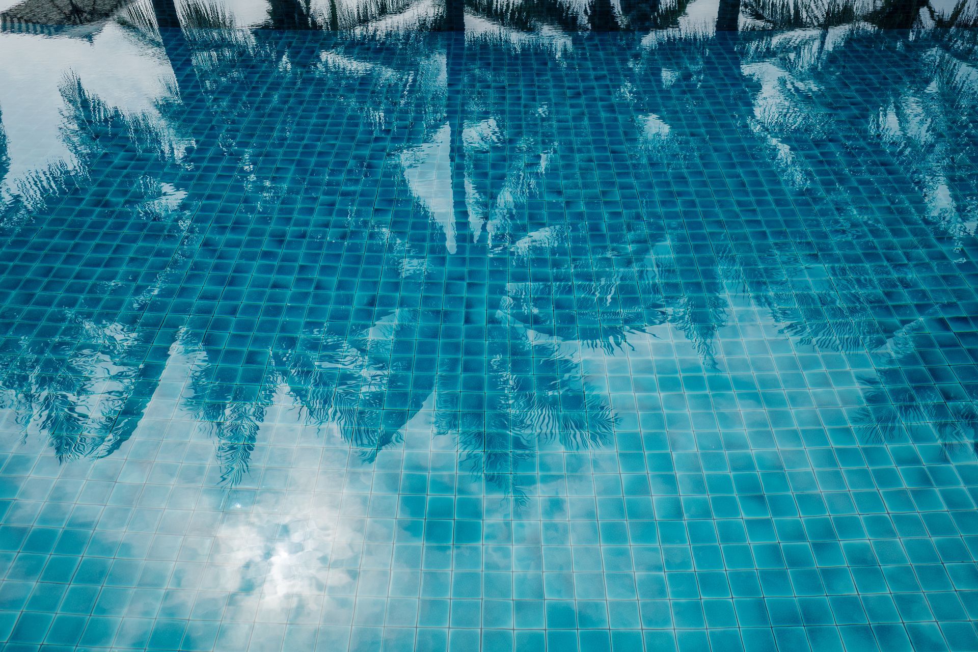 Tranquil swimming pool with a mosaic tiled floor