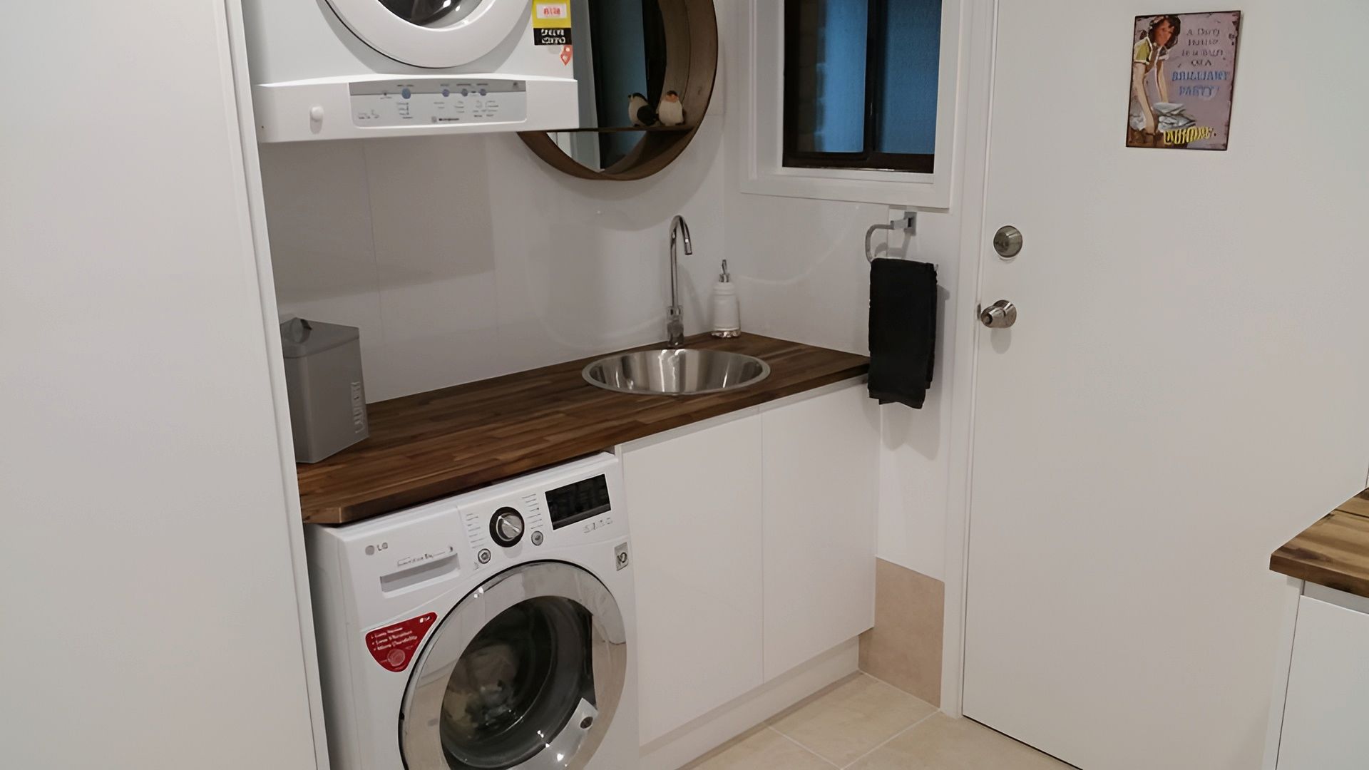 A Laundry Room With A Washer And Dryer — The Kitchen & Bathroom Doctor in Medowie, NSW