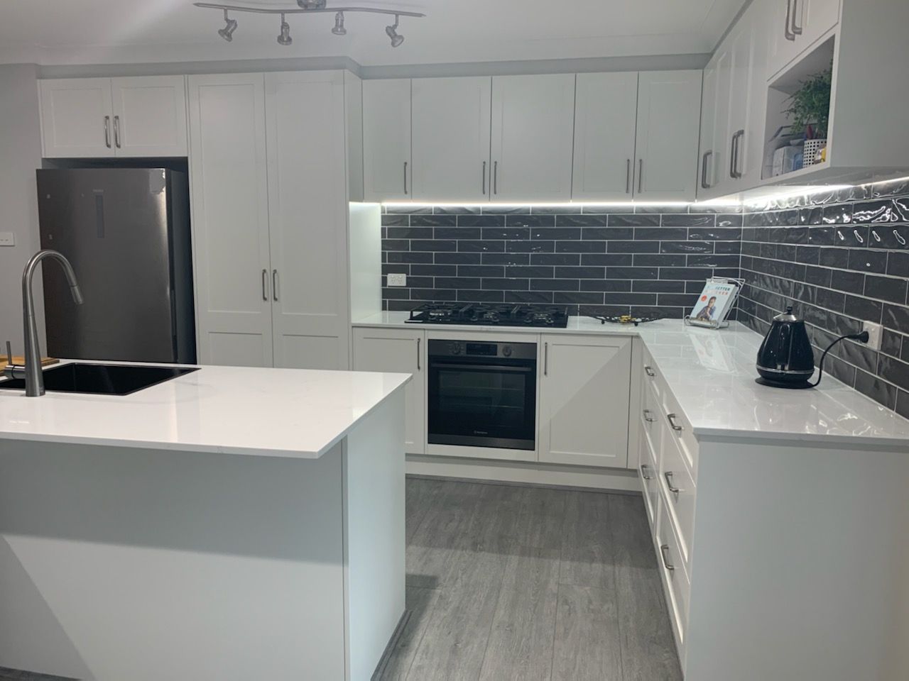 A Kitchen With White Cabinets And A Sink — The Kitchen & Bathroom Doctor in Medowie, NSW