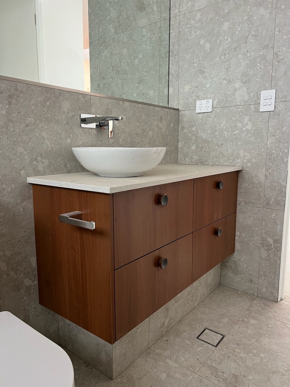 A Bathroom With A Sink, Mirror And Cabinets — The Kitchen & Bathroom Doctor in Soldiers Point, NSW