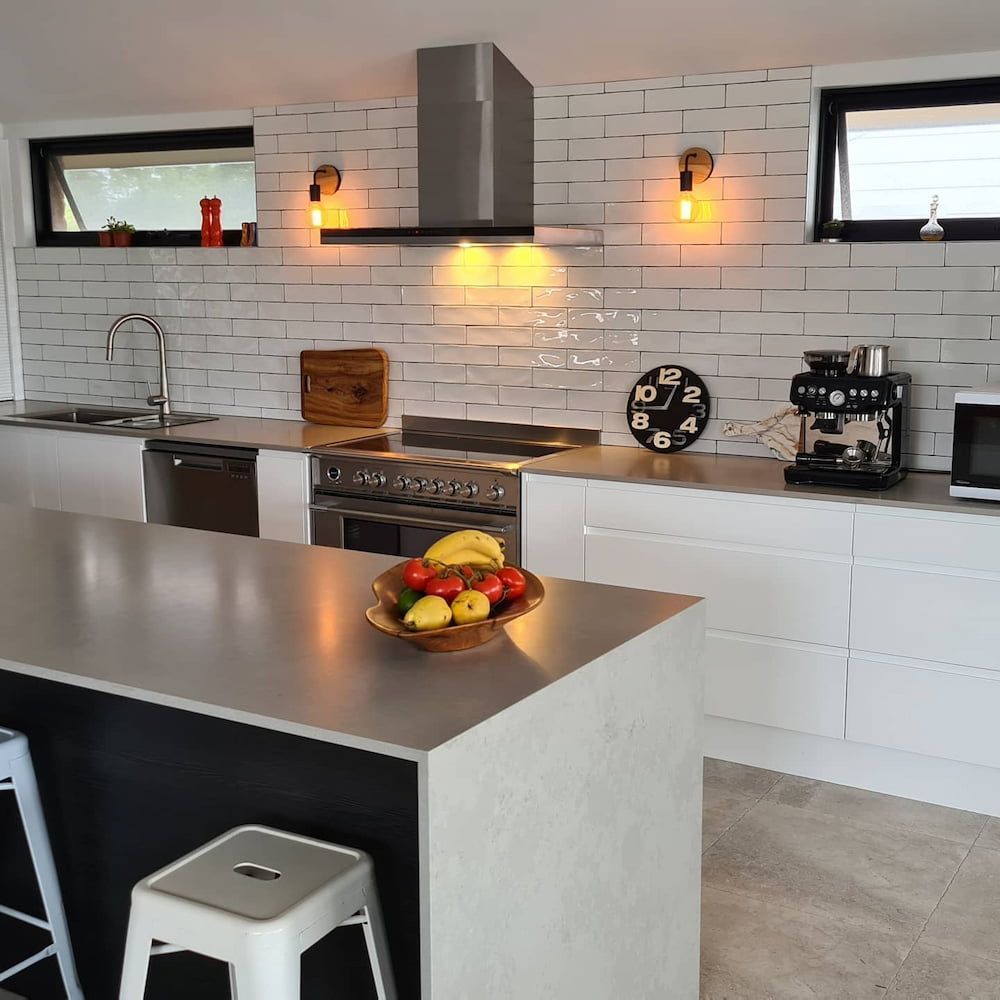 A Kitchen With A Bowl Of Fruit On The Counter — The Kitchen & Bathroom Doctor in Soldiers Point, NSW