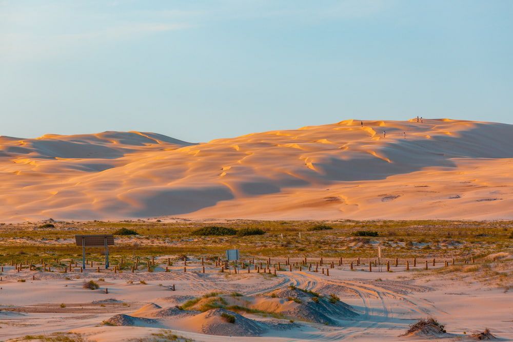 A Desert Landscape With Mountains And Sand Dunes In The Foreground — The Kitchen & Bathroom Doctor in Anna Bay, NSW