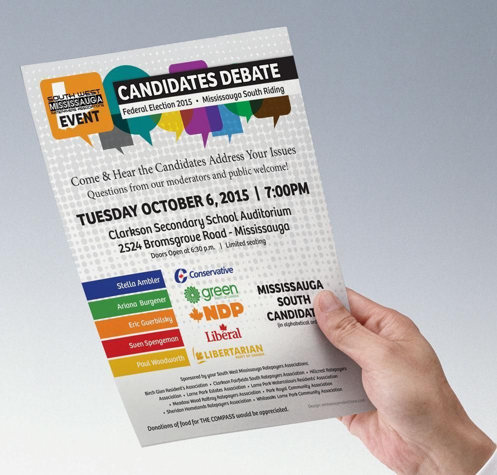 Hand holding a colorful candidates debate flyer with event details and logos on a light gray background
