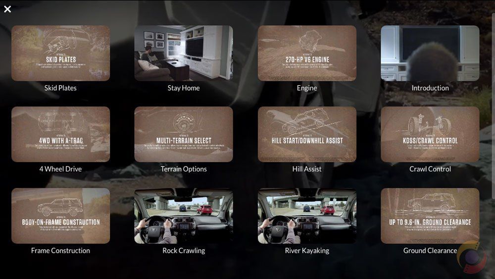Game menu with multiple rounded tiles showing scenes, including buildings, vehicles, and a moonlit landscape.