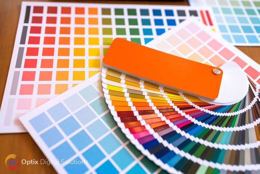 Color swatches and paint sample fans with orange, blue, and pink color palettes