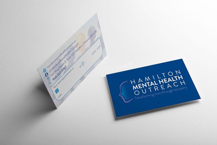 Two blue Hamilton Mental Health Outreach business cards on a light gray surface