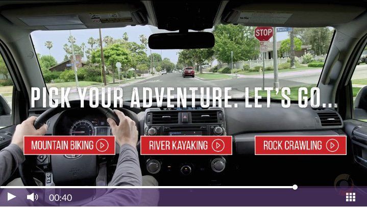 Driver's view on a road trip with overlay text: “PICK YOUR ADVENTURE. LET’S GO.” and activity buttons.