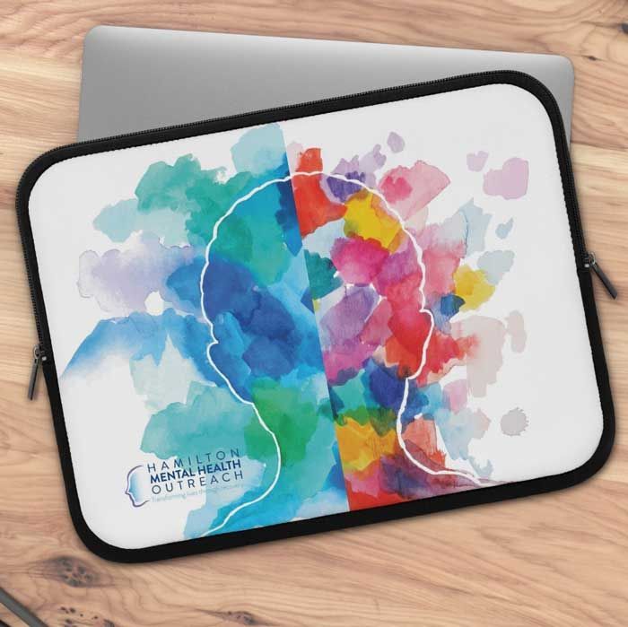 Colorful abstract watercolor on a tablet case with a black trim on a wooden table