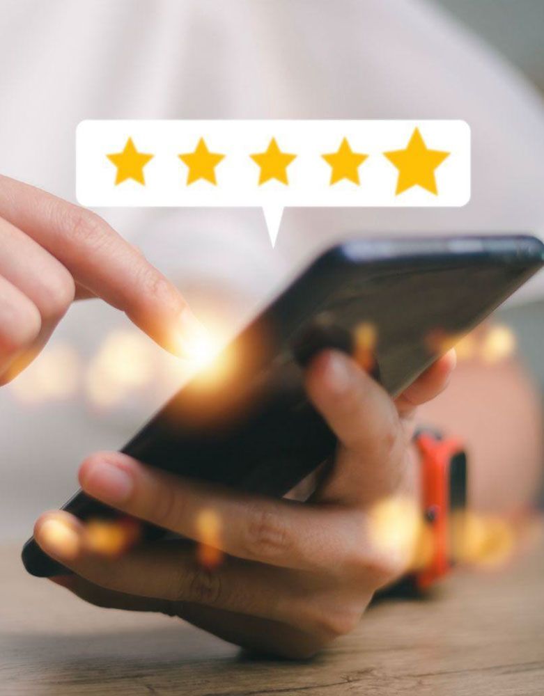 Hand tapping a smartphone with a 5-star rating bubble above it