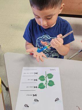 Childcare Franklin County — A Boy is Painting His Hand Blue In School in Columbus, OH Childcare Franklin County — A Boy is Painting His Hand Blue In School in Columbus, OH
