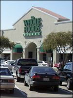 Whole Foods storefront with parked cars in front