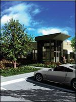 Modern building entrance with trees, blue sky, and a silver car parked in front