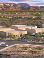 Modern beige houses in a desert neighborhood with mountains in the background
