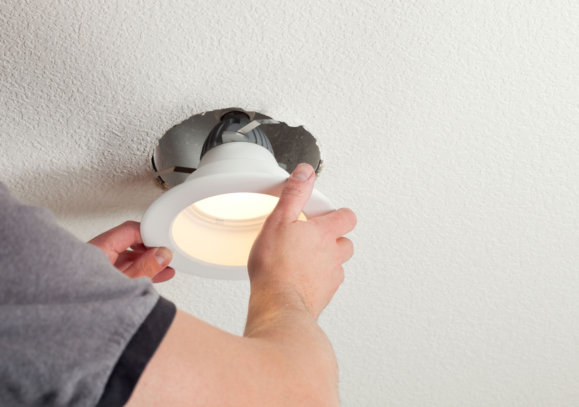 A Person Is Installing a Light in the Ceiling — HBP Electrical LLC — Muscle Shoals, AL