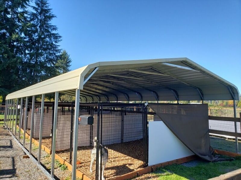 A horse stable with a canopy over it.