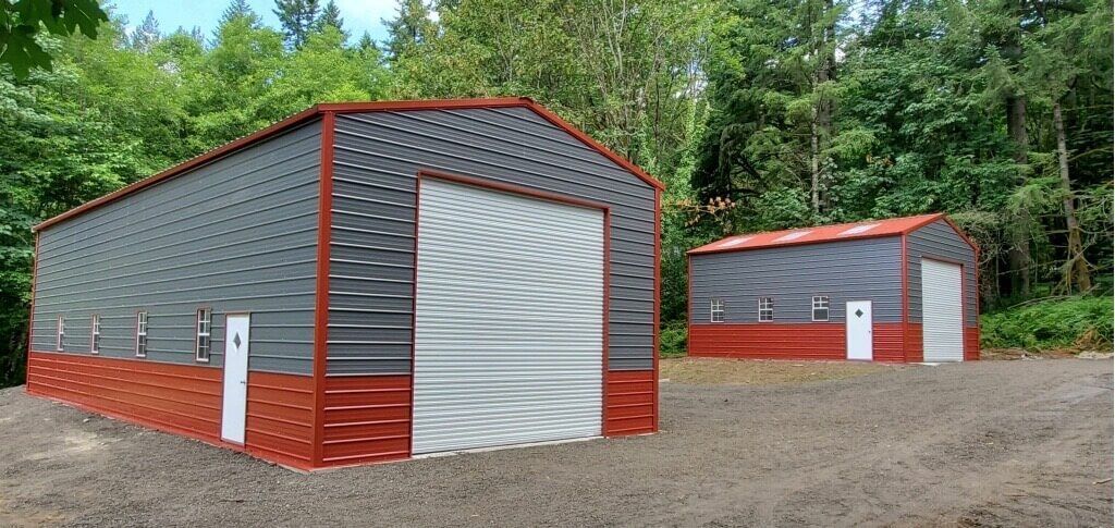 Two garages are sitting next to each other in a gravel lot.