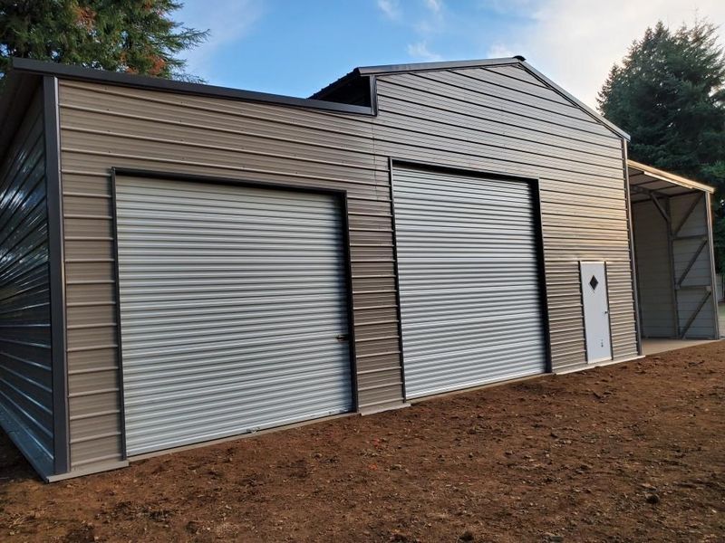 A metal building with two garage doors and a door.