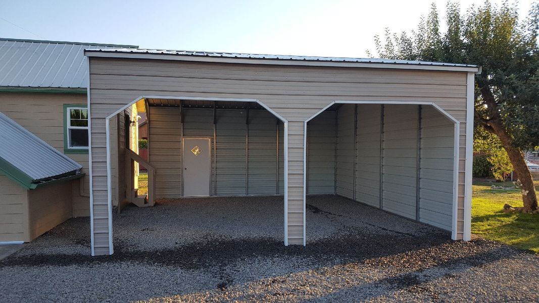 A garage with a roof and a door is next to a house.