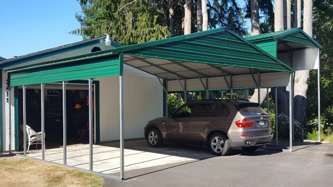 A car is parked under a canopy in front of a garage.