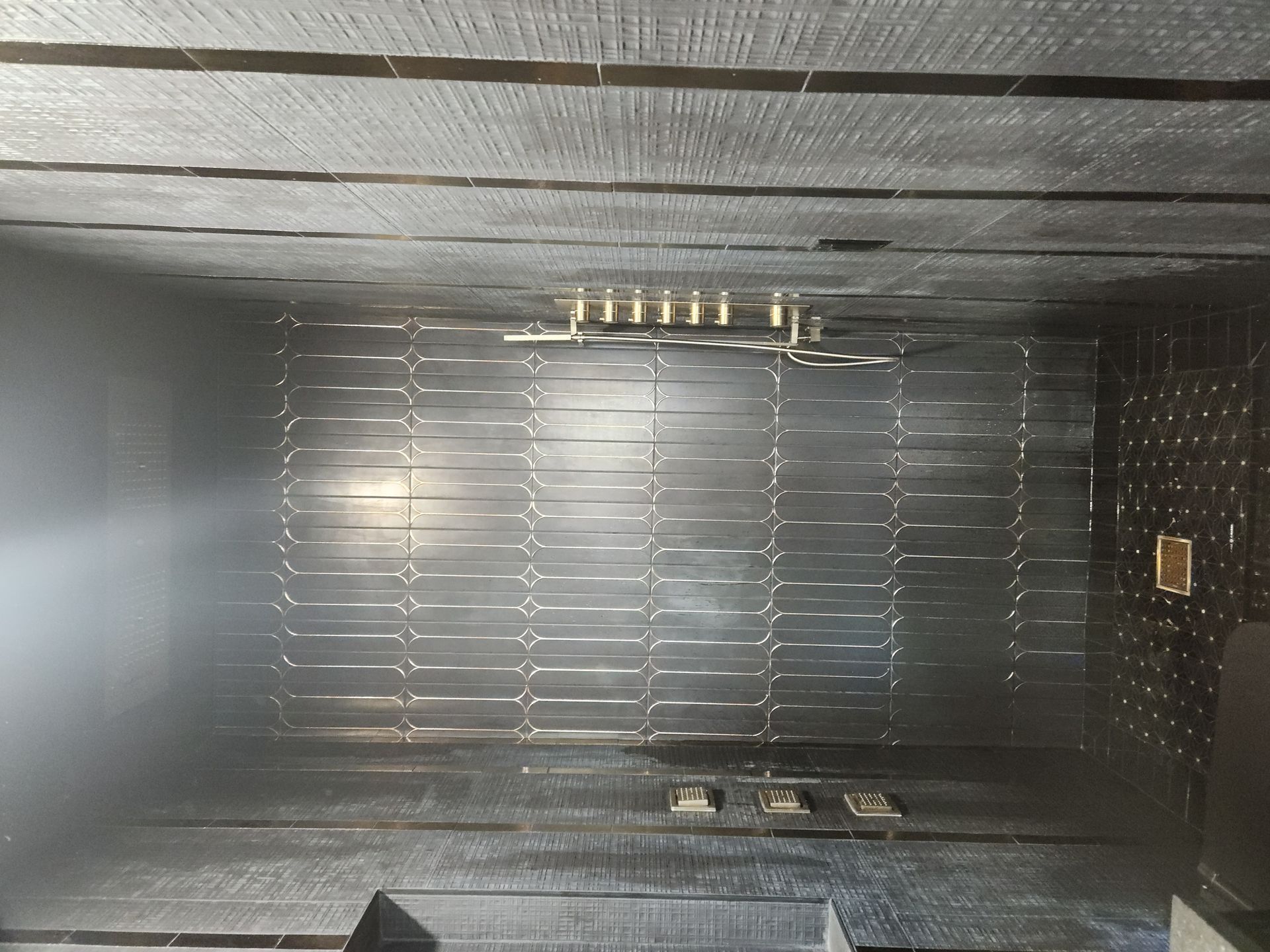 Interior of a metallic cargo container with riveted walls and a bright light at the far end