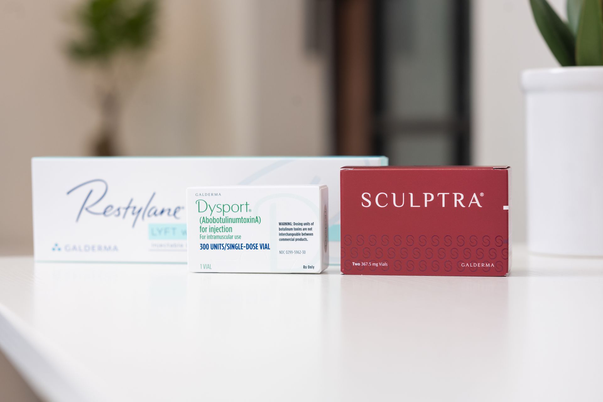 a box of restylane and a box of sculptra are sitting on a table .