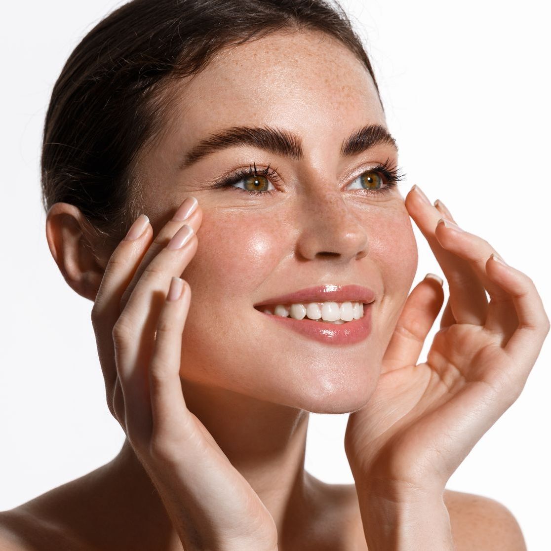 a close up of a woman 's face with her hand on her face .