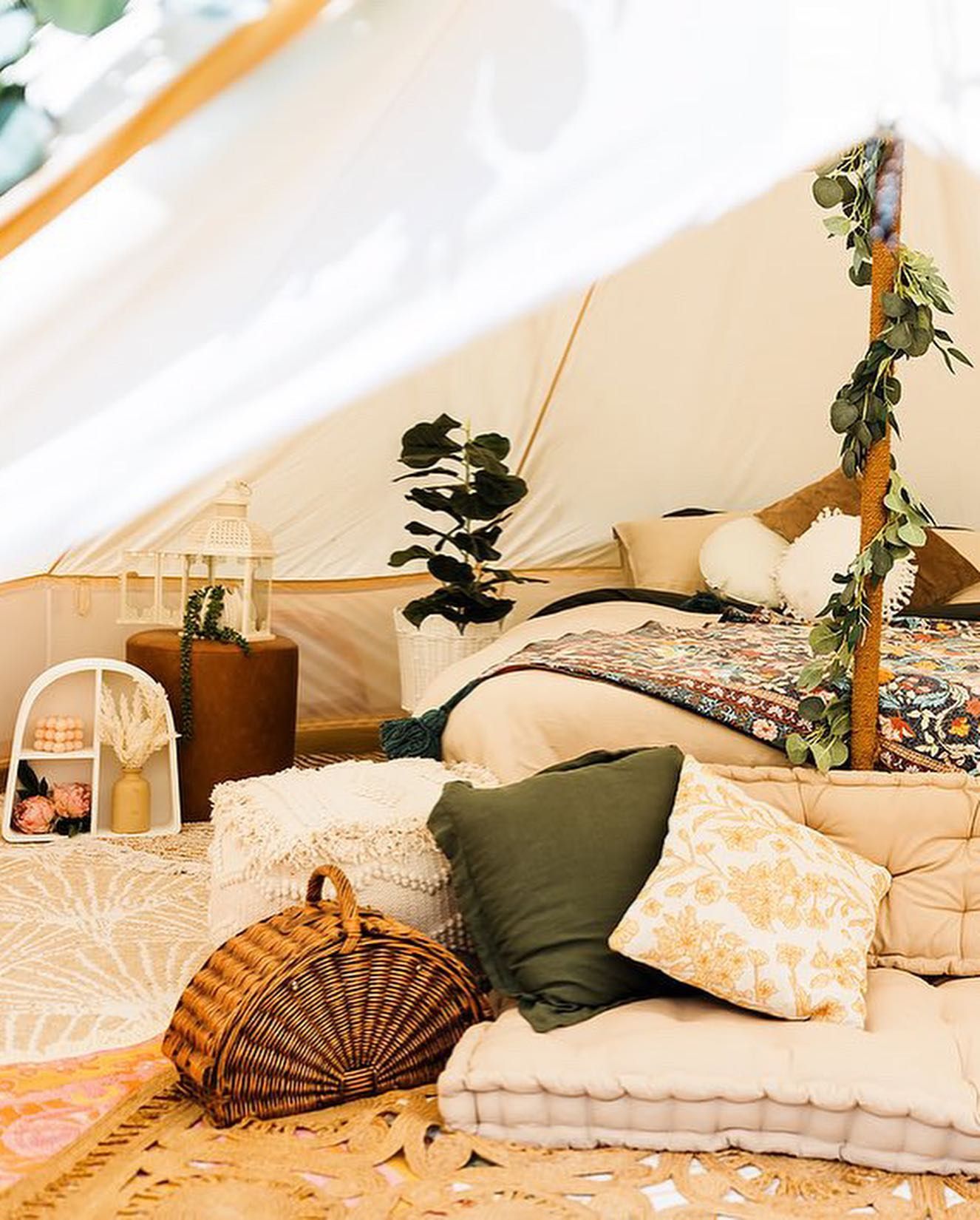 Cozy belltent interior with bed, cushions — Amanda Douglass Catering Service in Corlette, NSW