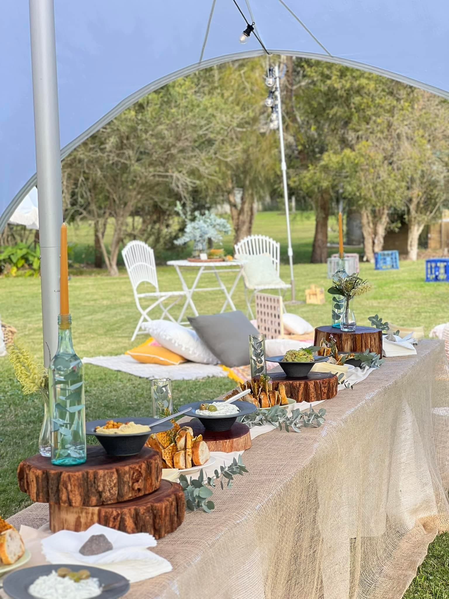 Outdoor Picnic Setting With Food on Wooden Platters — Amanda Douglass Catering Service in Corlette, NSW