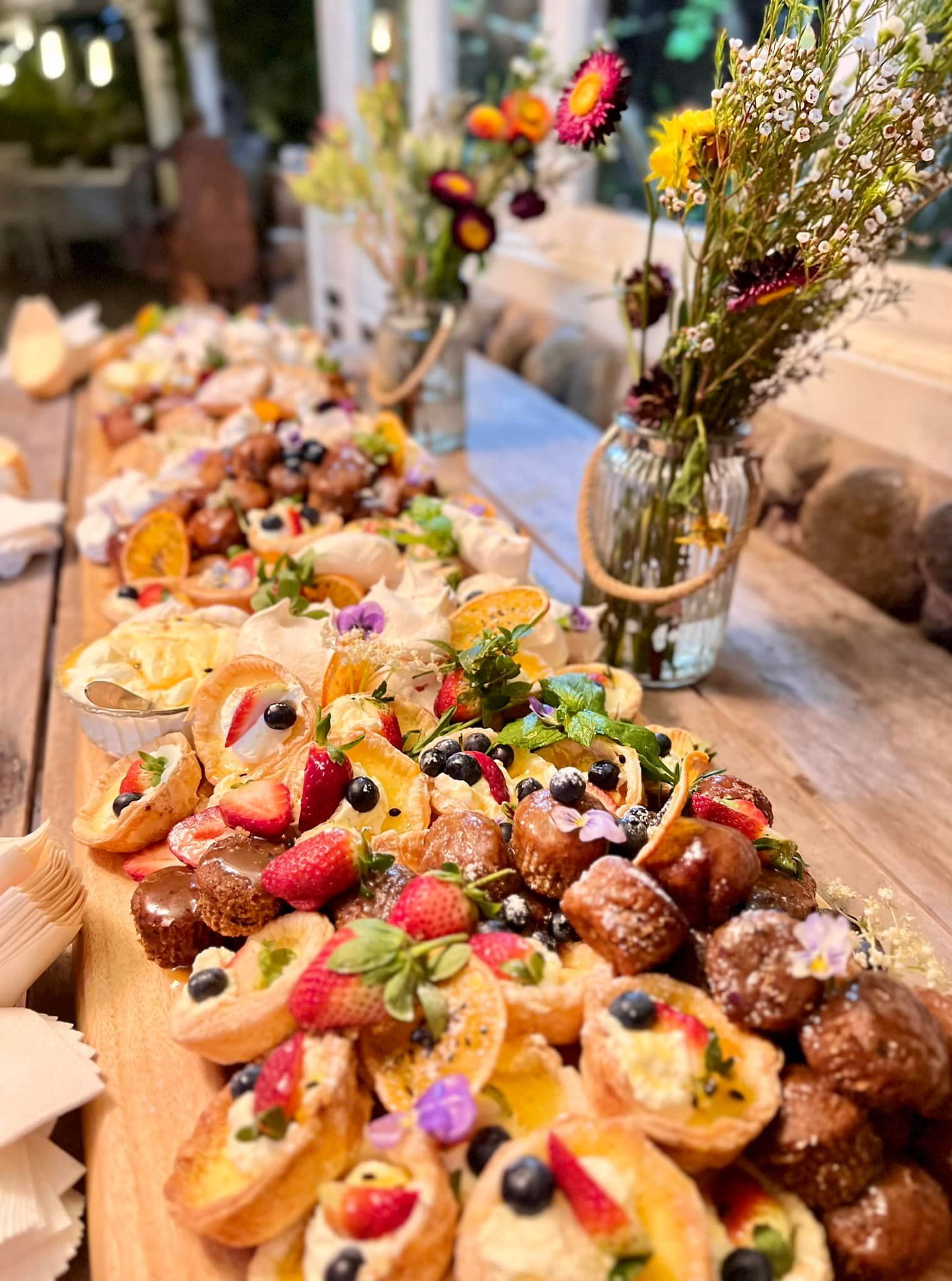 Charcuterie Board With Pastries, Fruit, Flowers, and Greenery — Amanda Douglass Catering Service in Corlette, NSW