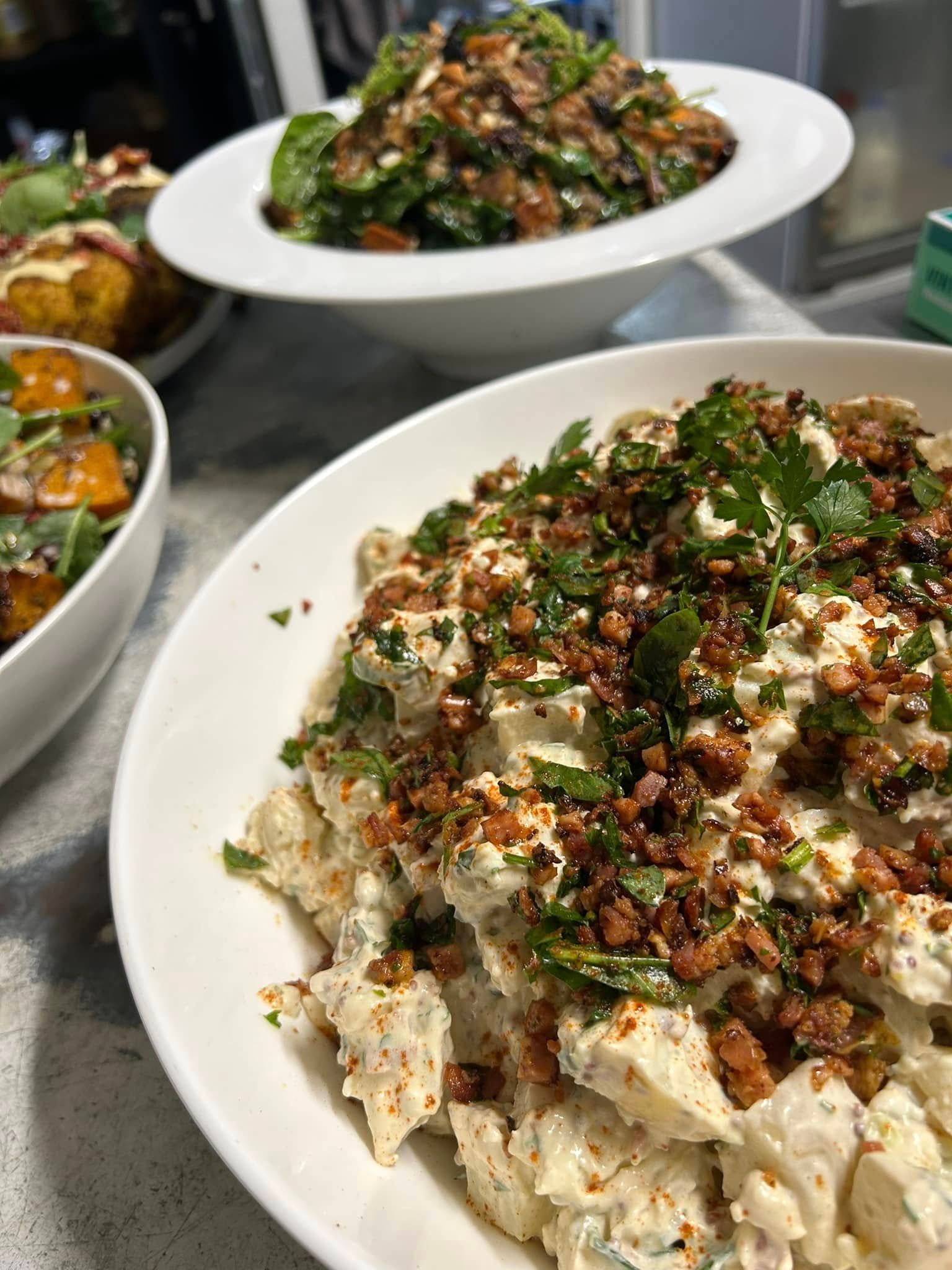 Close-up of Creamy Potato Salad Topped With Herbs and Crunchy Bits — Amanda Douglass Catering Service in Corlette, NSW