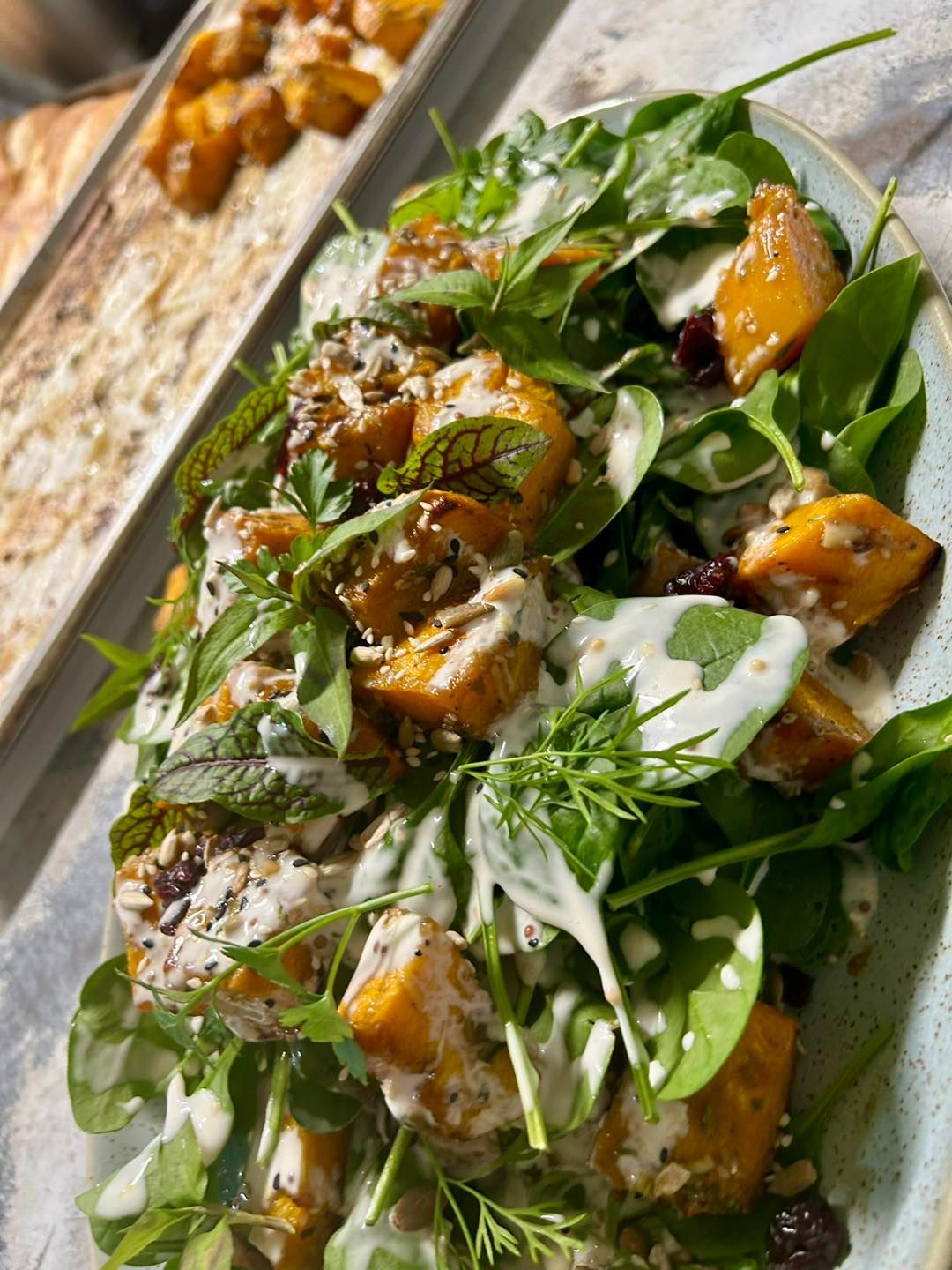 An extreme close up of a sweet potato salad with dressing — Amanda Douglass Catering Service in Corlette, NSW