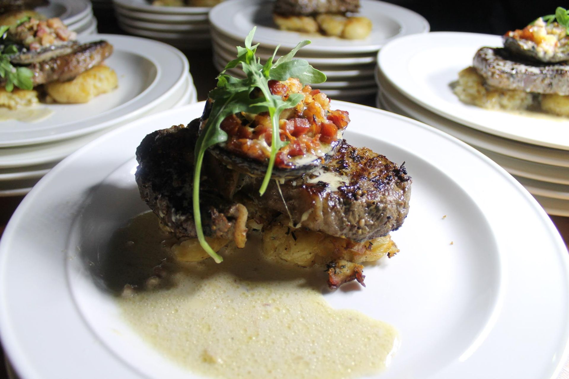 Plated steak with potatoes, sauce, and garnish, ready to serve — Amanda Douglass Catering Service in Corlette, NSW
