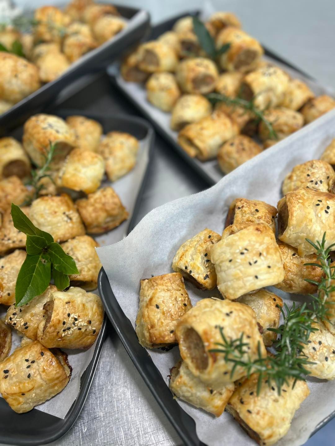 Three Trays of sausage rolls topped with sesame seeds -  Amanda Douglass Catering Service in Corlette, NSW