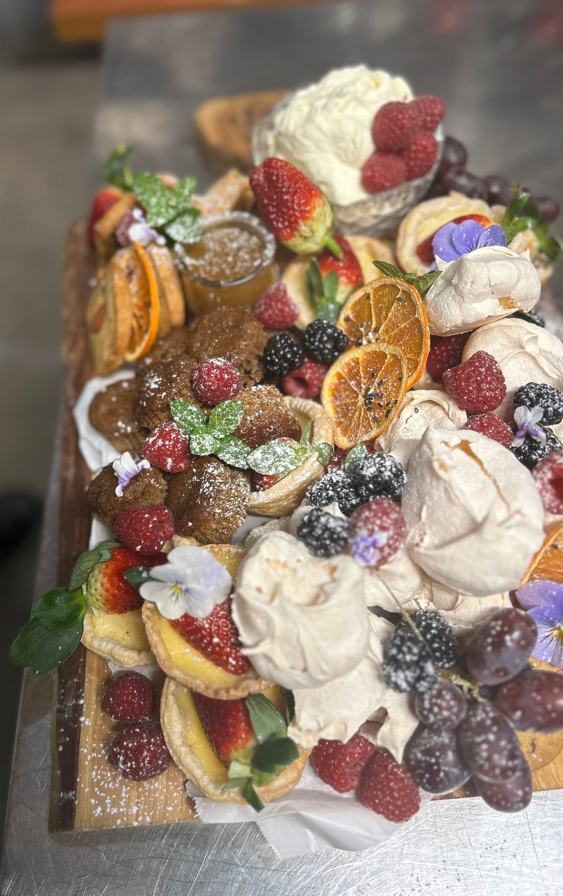 Charcuterie Board With Pastries, Fruit, Flowers, and Greenery — Amanda Douglass Catering Service in Corlette, NSW