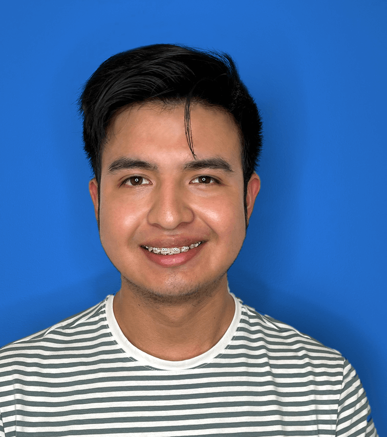 A young man smiling with braces by orthodontist in Montebello in front of a blue background.