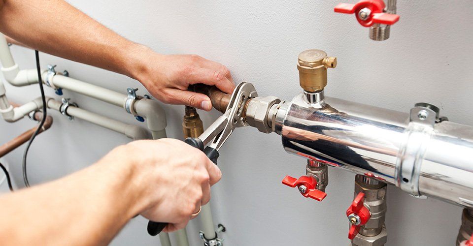 Person fixes pipe