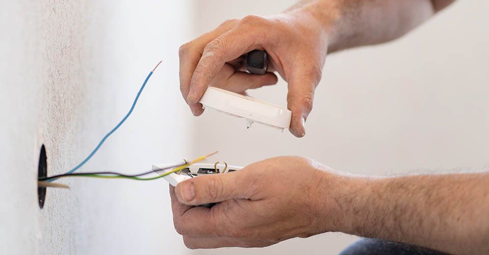 Person fixes fire detector